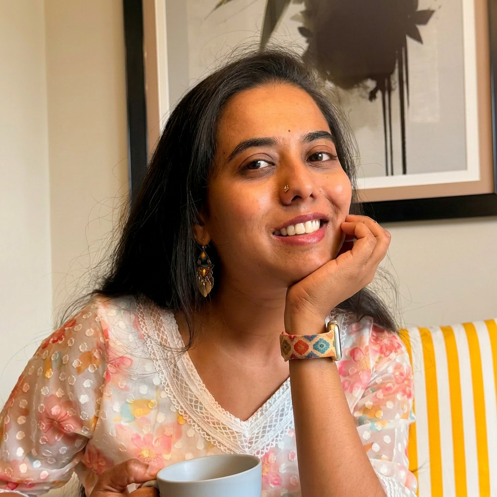 Sri, founder of The Lentil Pop Studio, smiling with a cup of chai